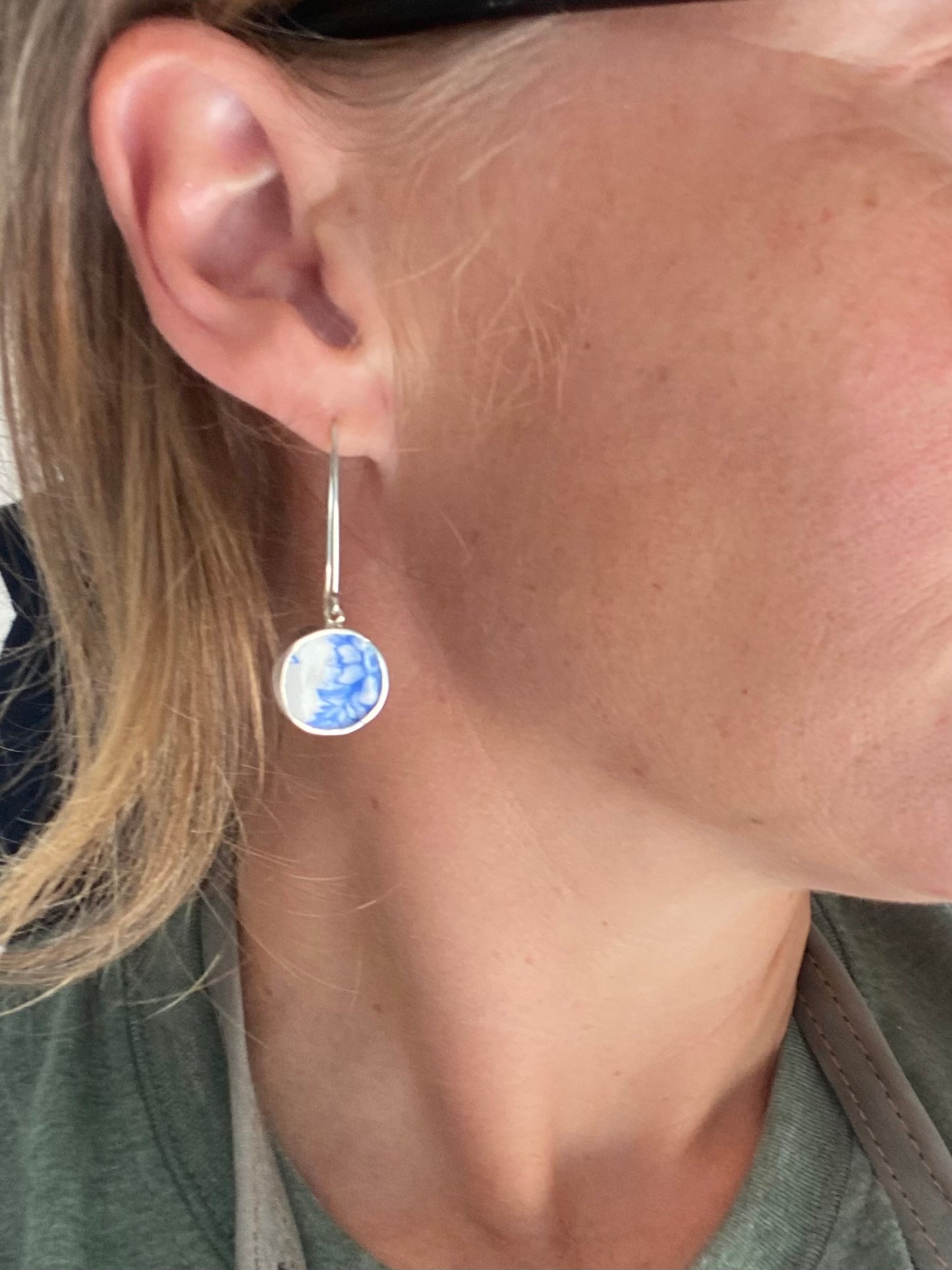 Close-up of Customisable Vintage China Silver Earring being worn, showcasing intricate blue floral design.