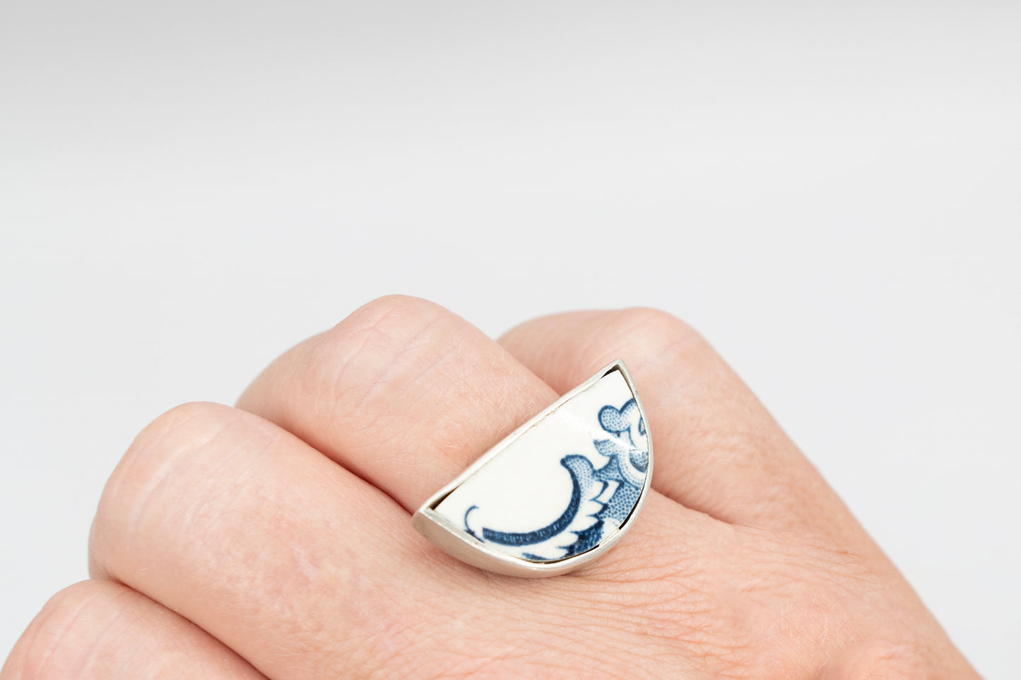 Half round ring with blue and white antique ceramic set in silver