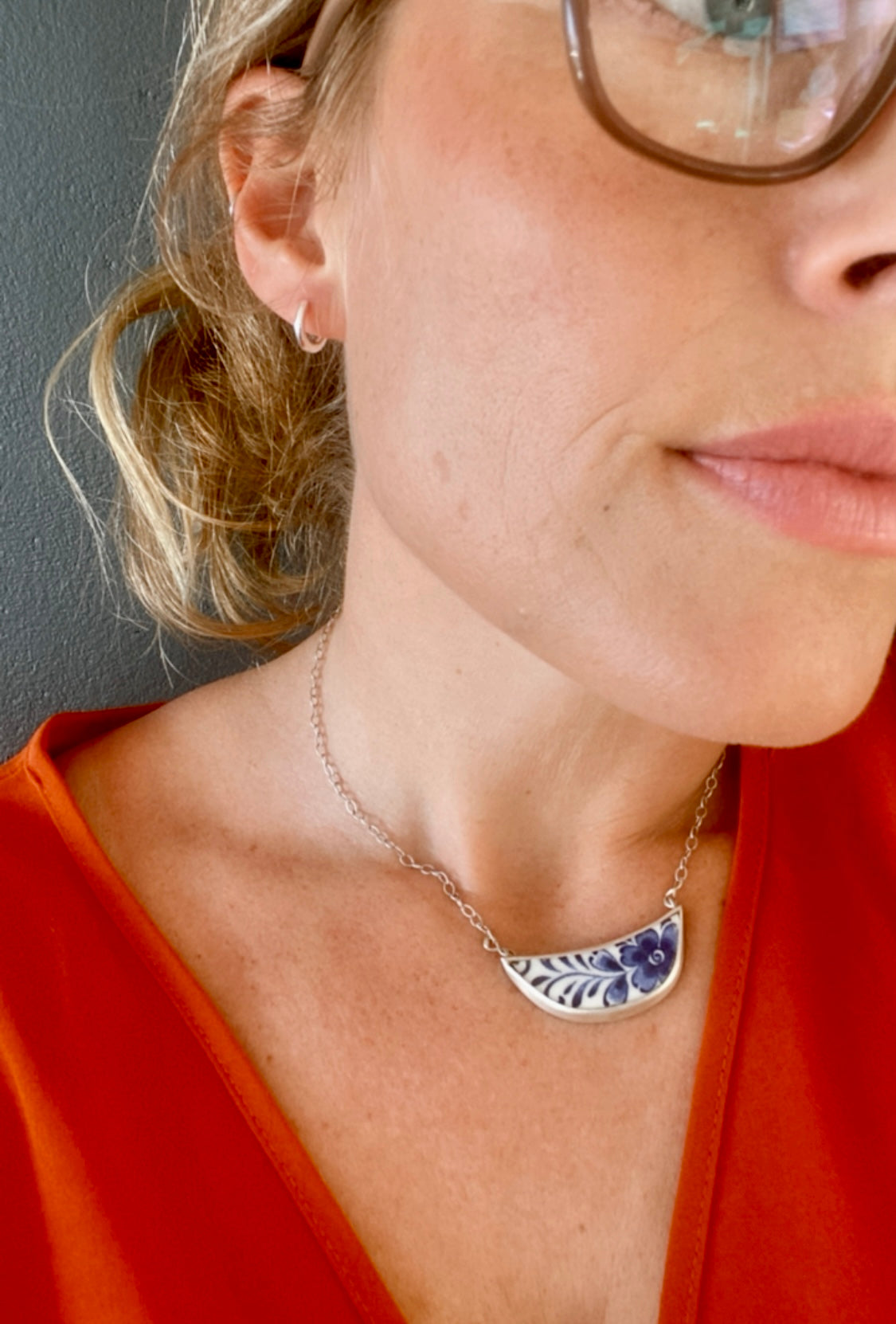 Woman wearing small sterling silver hoops