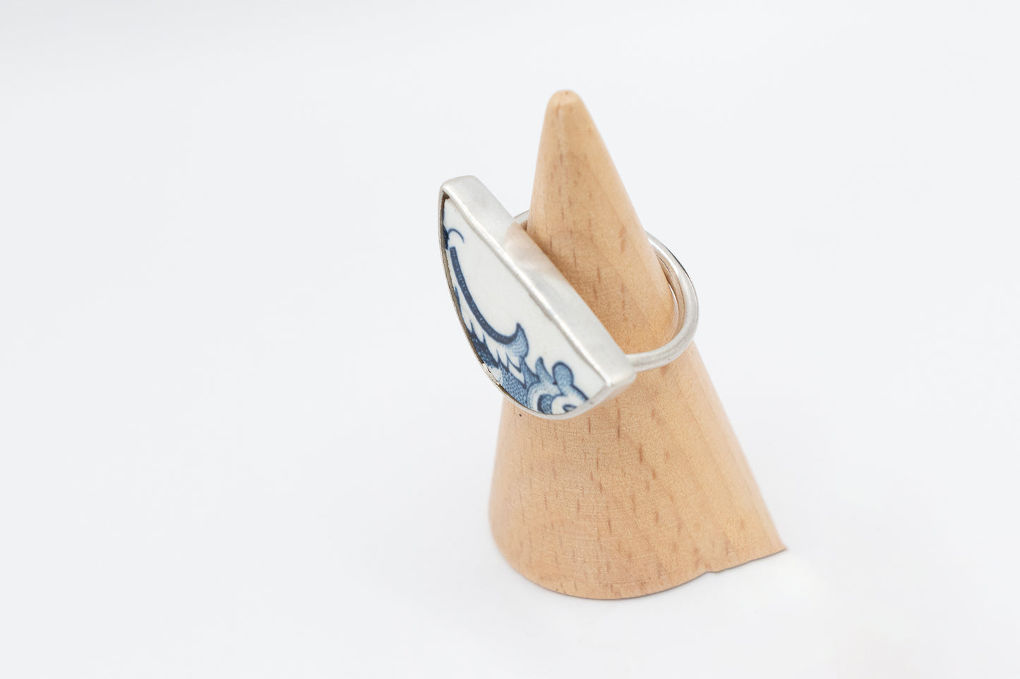 Half round ring with blue and white antique ceramic set in silver