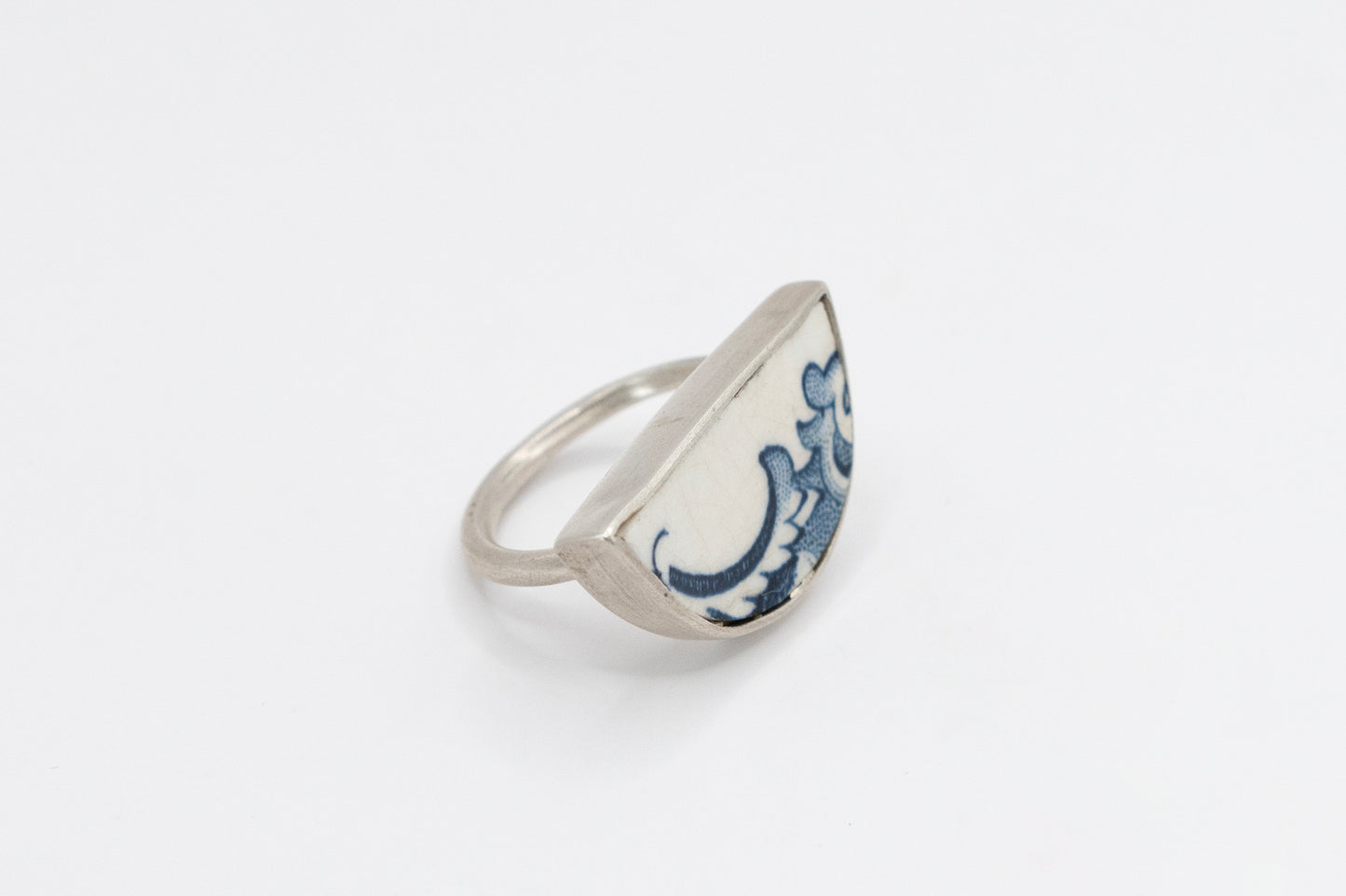 Half round ring with blue and white antique ceramic set in silver