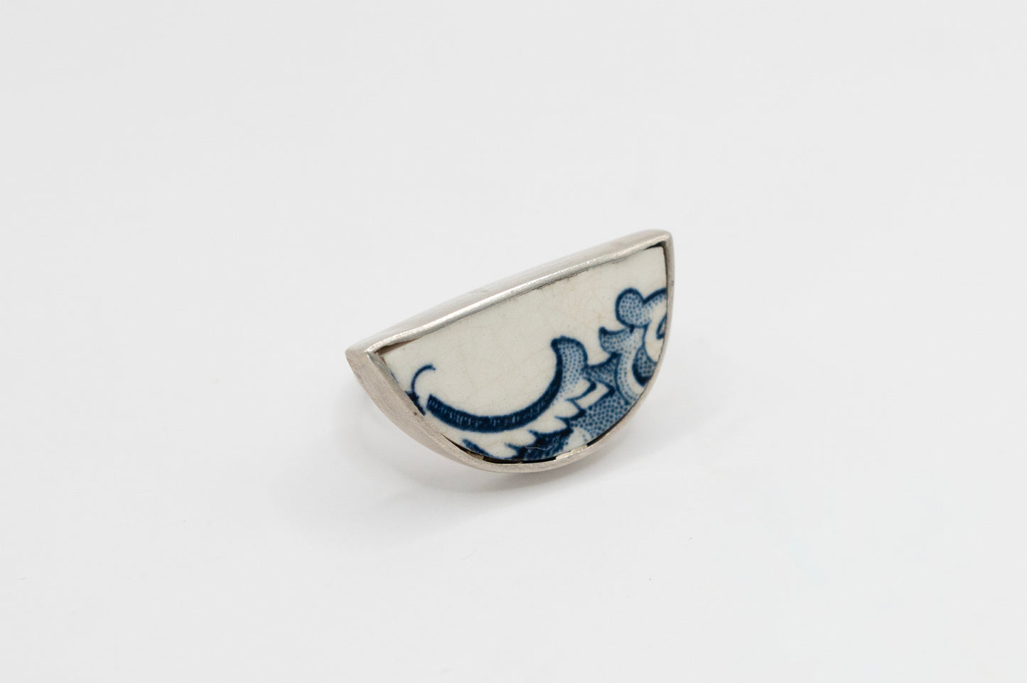 Half round ring with blue and white antique ceramic set in silver