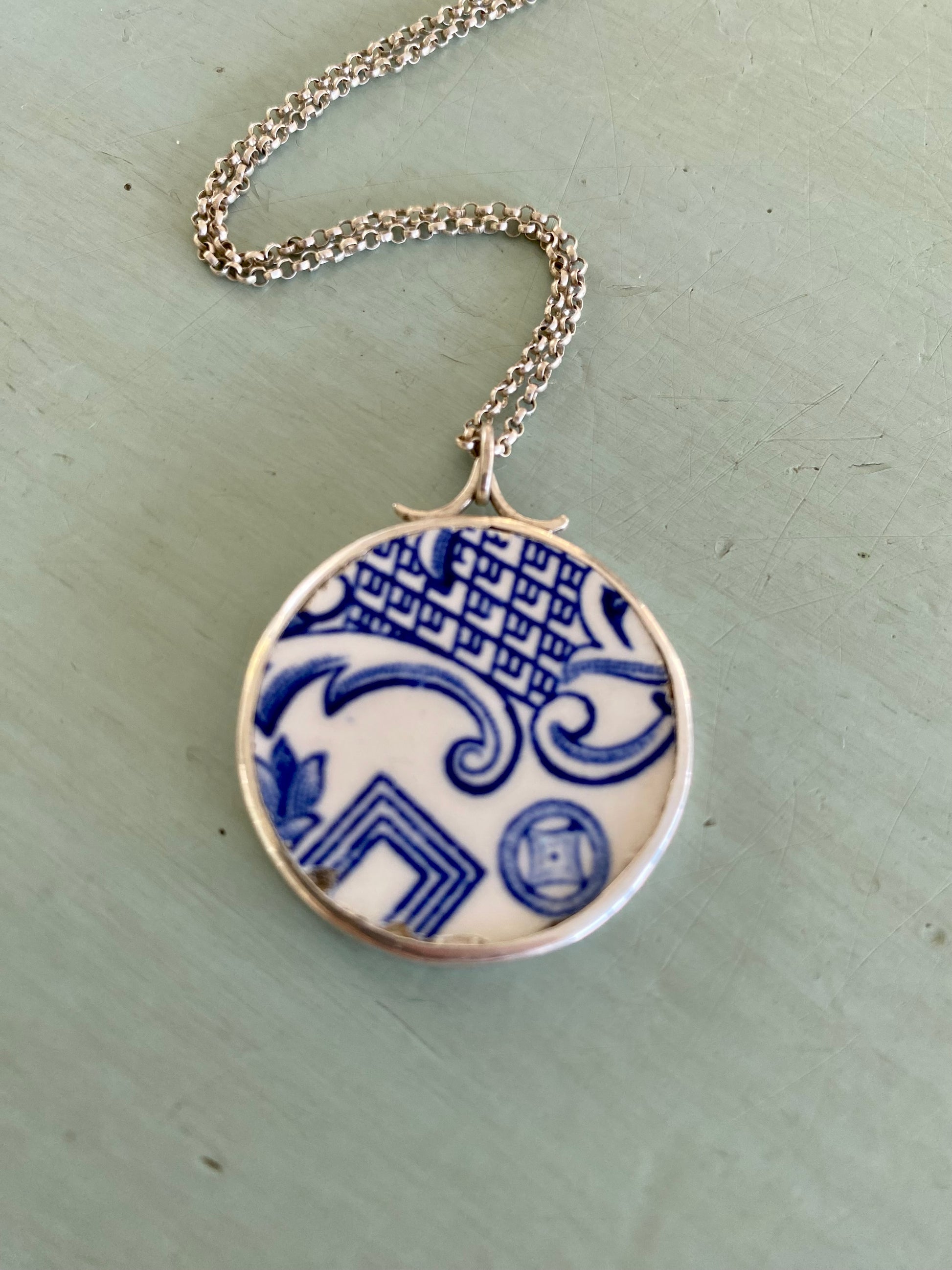 Elegant Willow Pattern Ceramic and Sterling Silver Pendant - Close-up View.