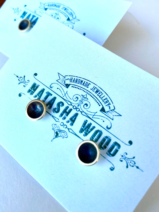 Classic black domed brass stud earrings presented on a custom Natasha Wood Jewellery card