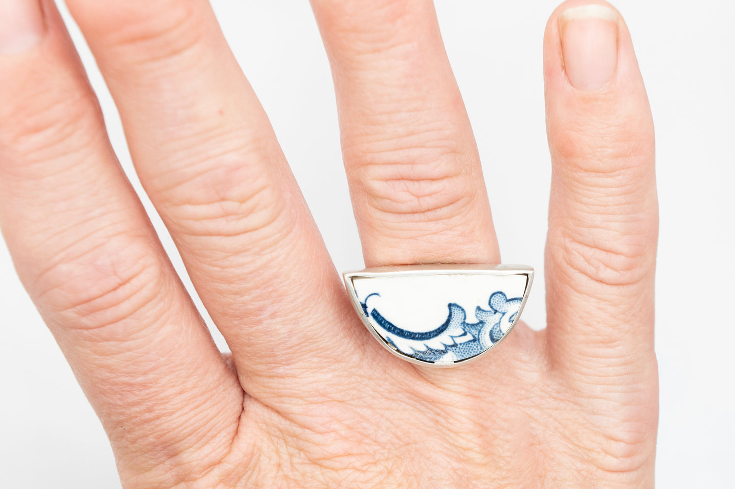 Half round ring with blue and white antique ceramic set in silver
