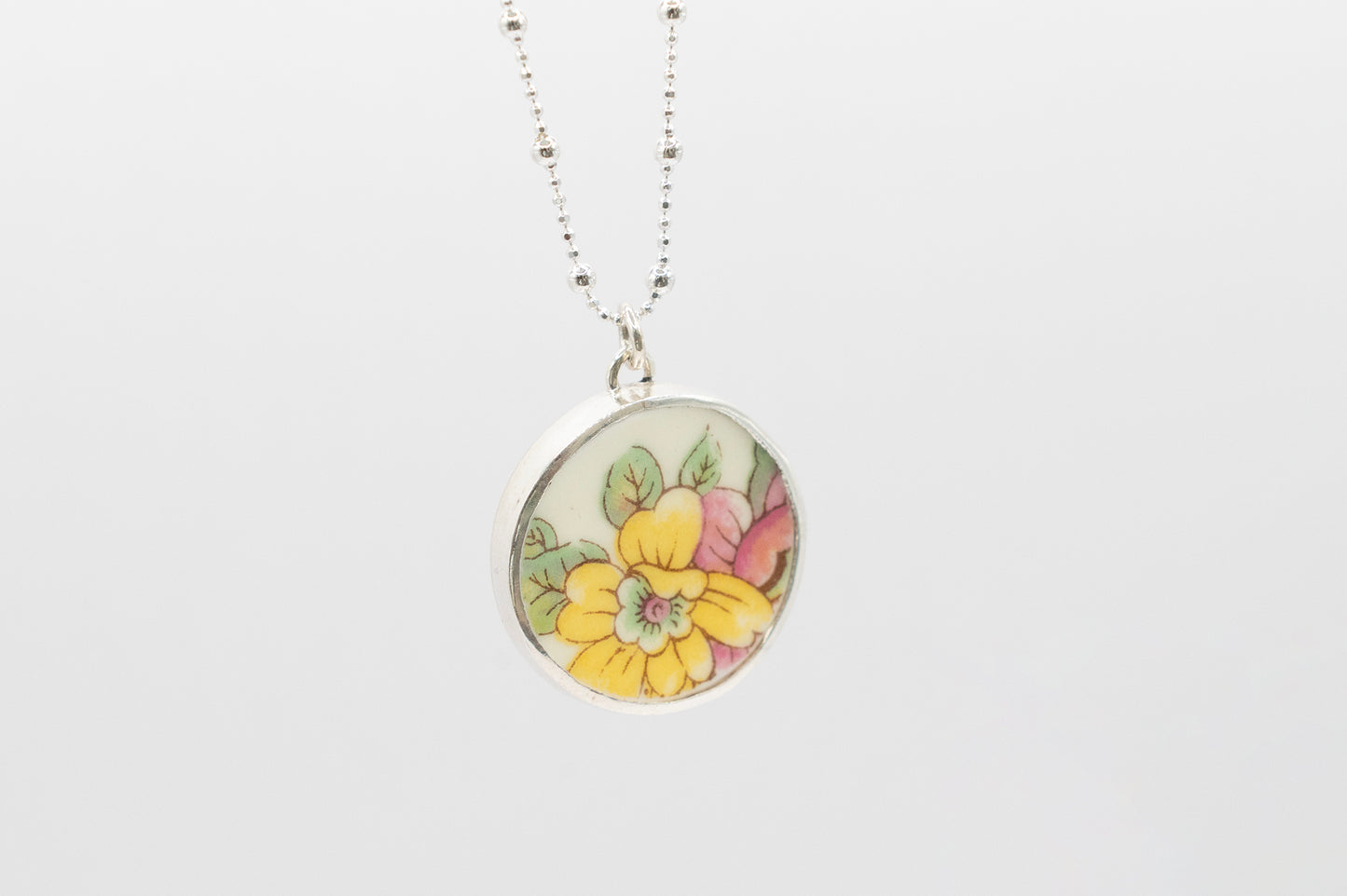 Antique Ceramic floral design and silver pendant