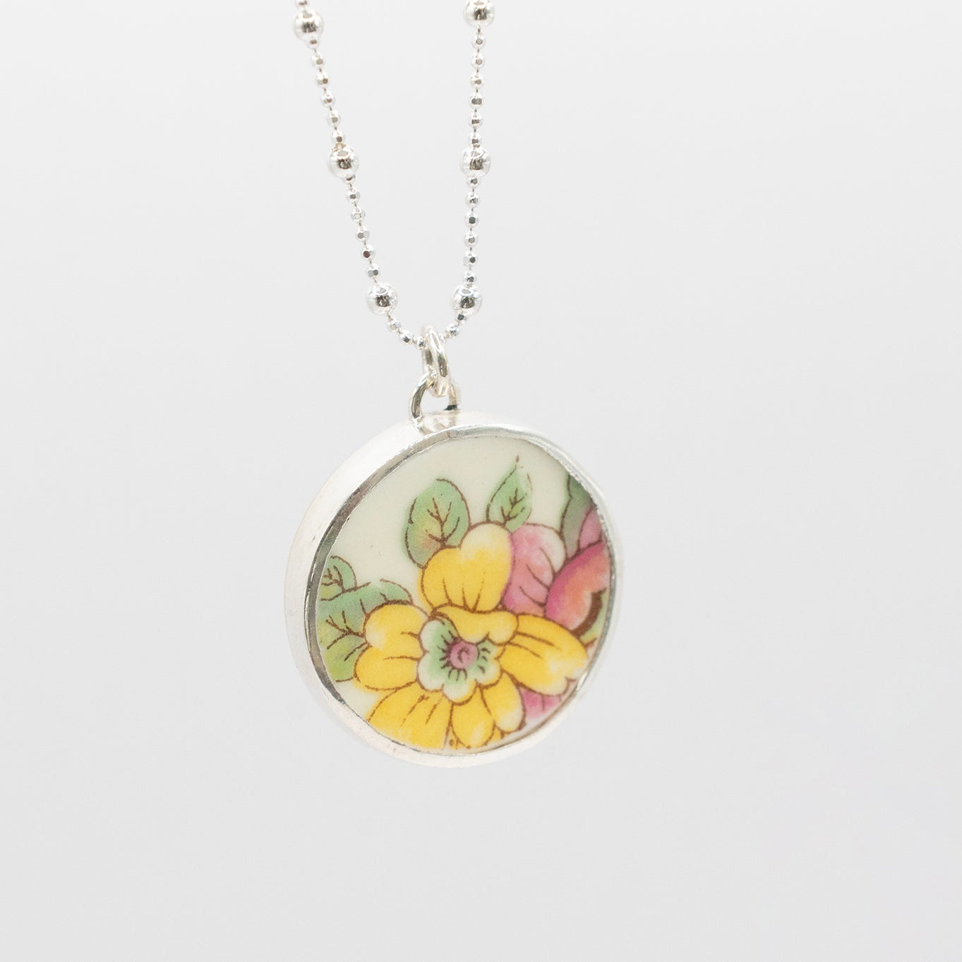 Antique Ceramic floral design and silver pendant