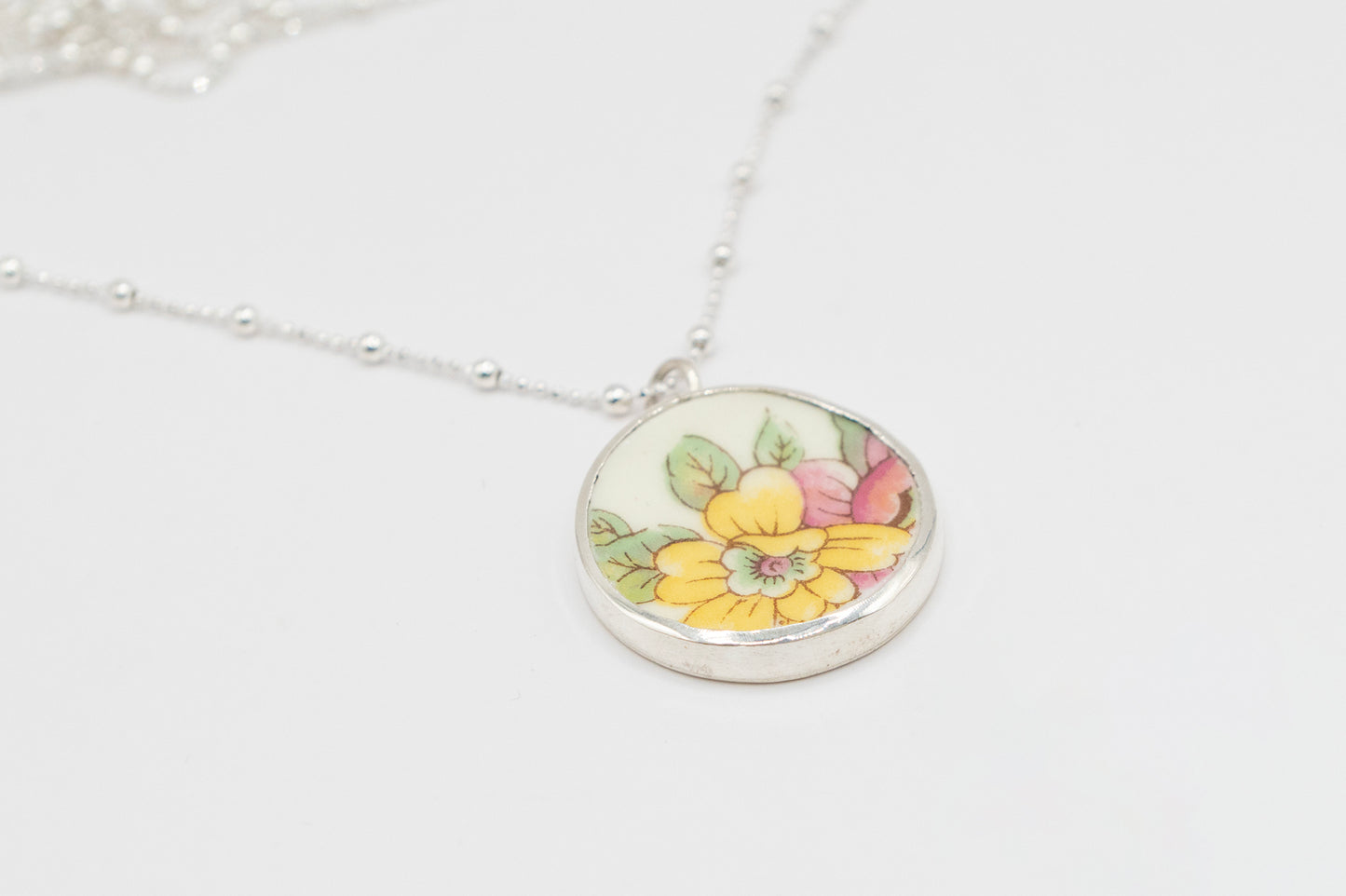 Antique Ceramic floral design and silver pendant