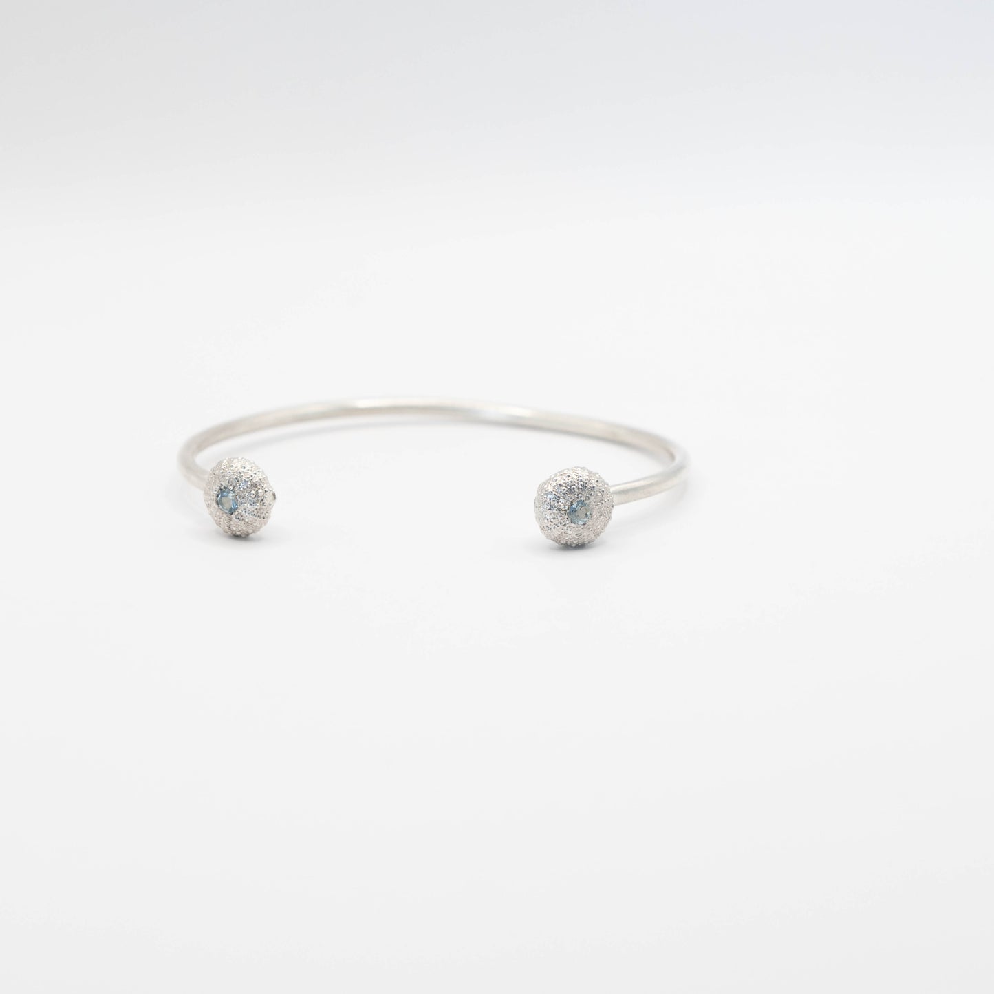 sterling silver sea urchin bangle with blue topaz fron view