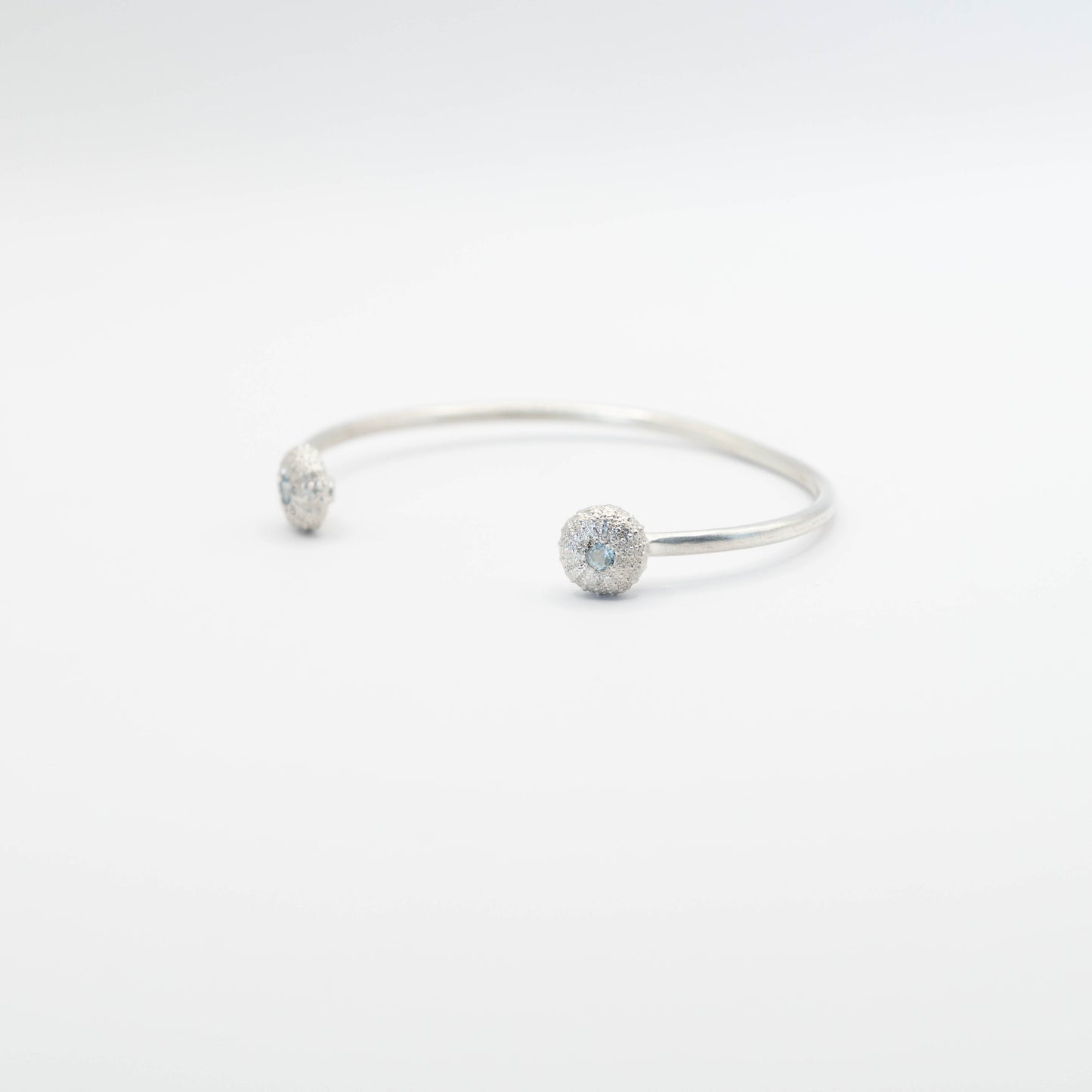 sterling silver sea urchin bangle with blue topaz from the side view