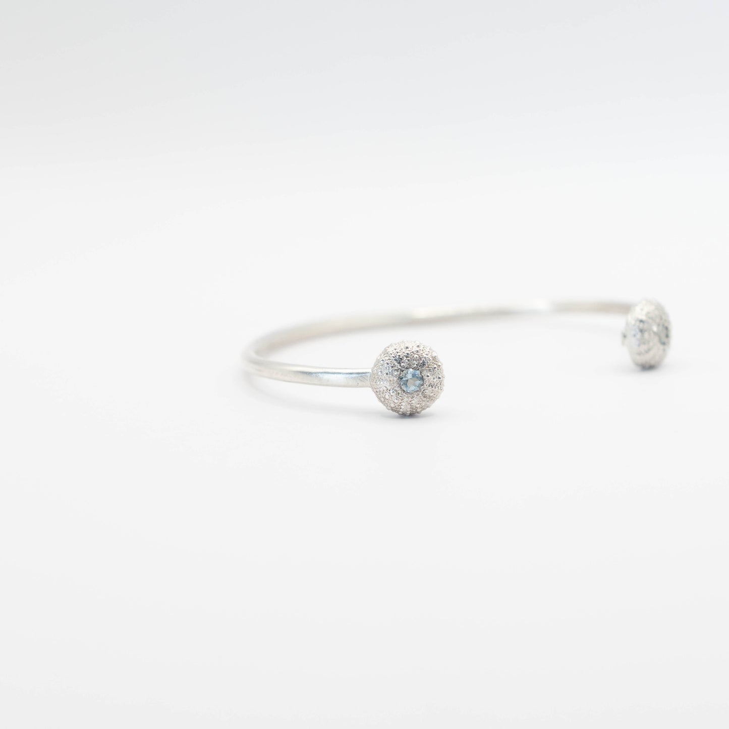 sterling silver sea urchin bangle with blue topaz left view