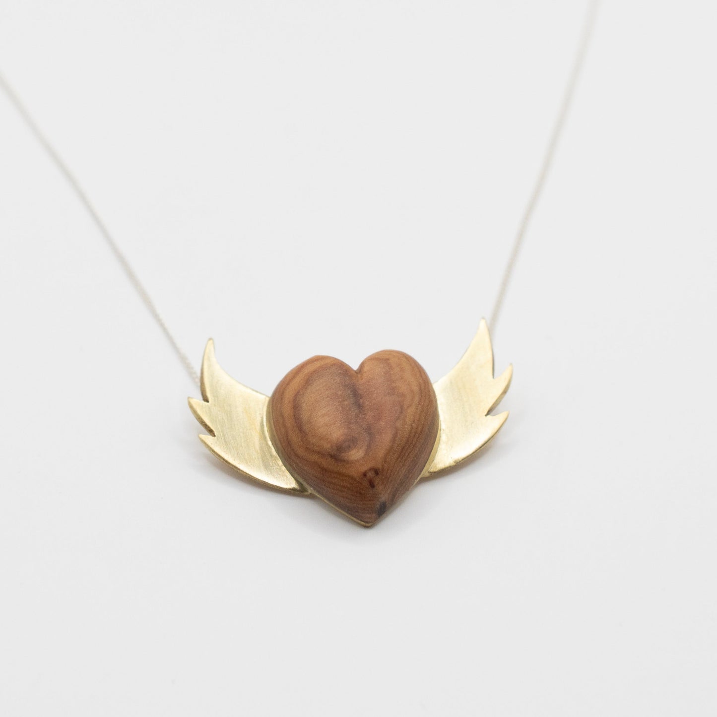 Olive Wood Heart Necklace with Brass Wings - front view flat lay, handcrafted by Natasha Wood Jewellery