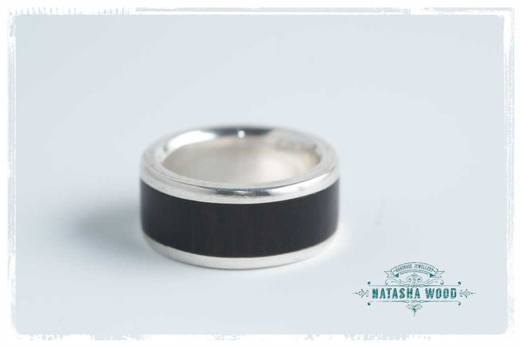 Side view of the sterling silver ring with African Blackwood inlay presenting a sleek profile