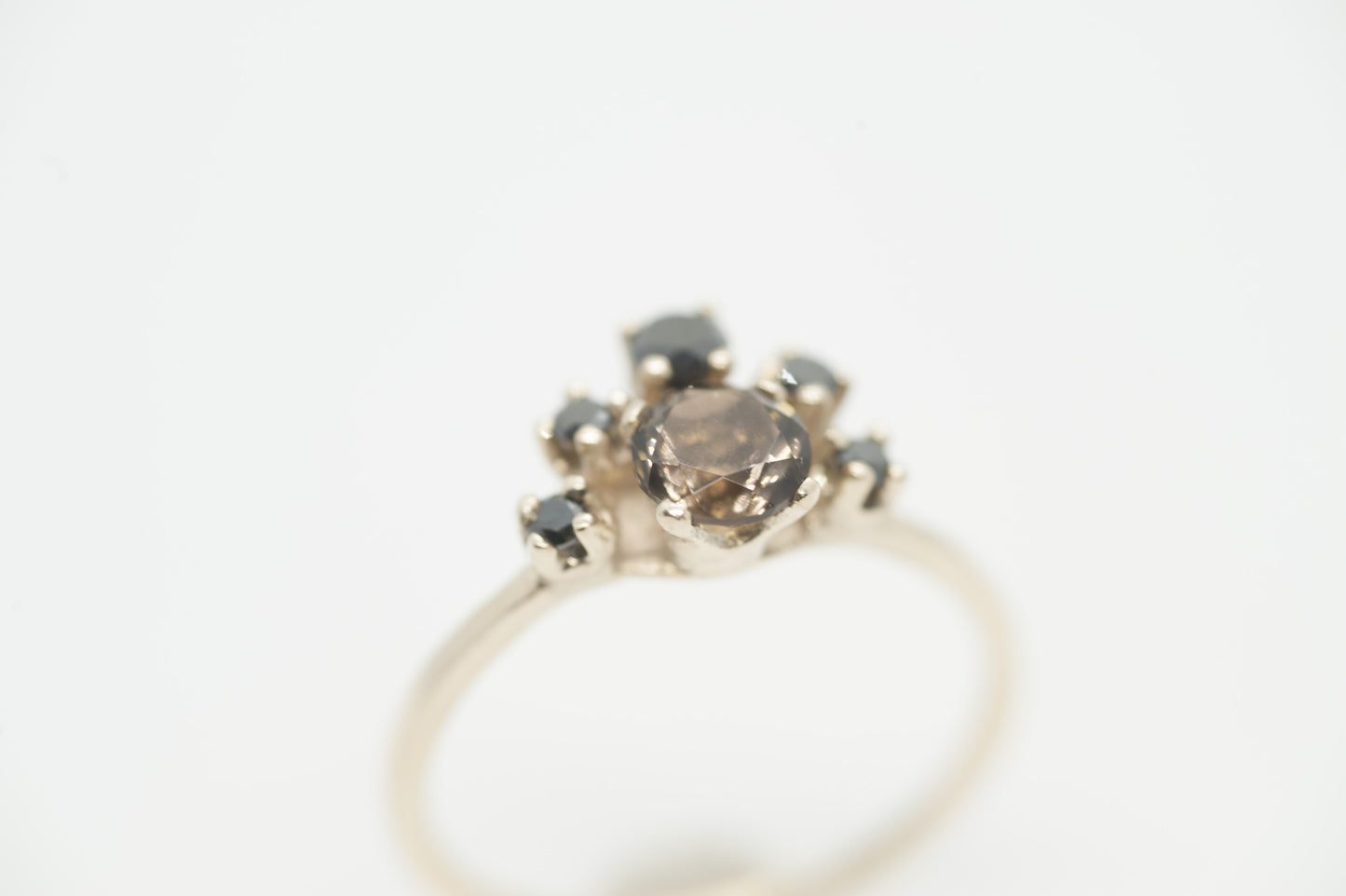 Close-up of a custom gold ring showing the detailed setting