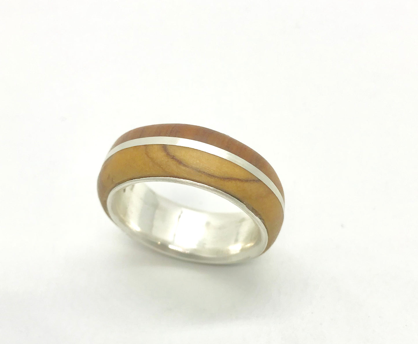 Close-up of the comfortable interior fit of the double-layer silver band with olive wood.