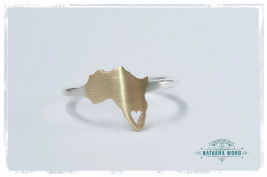 Close-up of the brass and silver Africa ring showing the heart cutout detail.