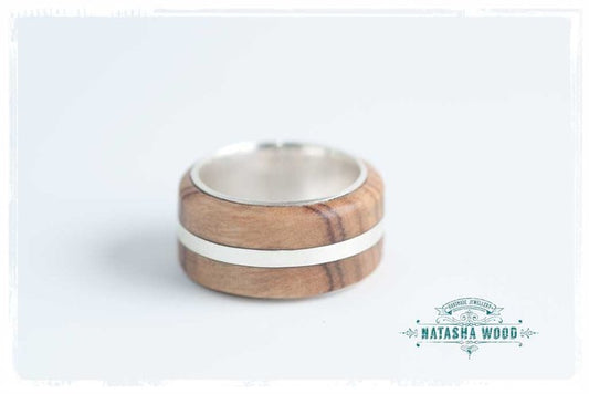 Top view of double-layer olive wood and sterling silver band showcasing the light wood inlay