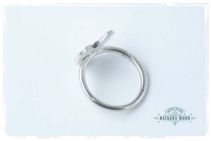 Protea Heart Ring shown from above, emphasizing the heart shape and the detailed protea engraving.
