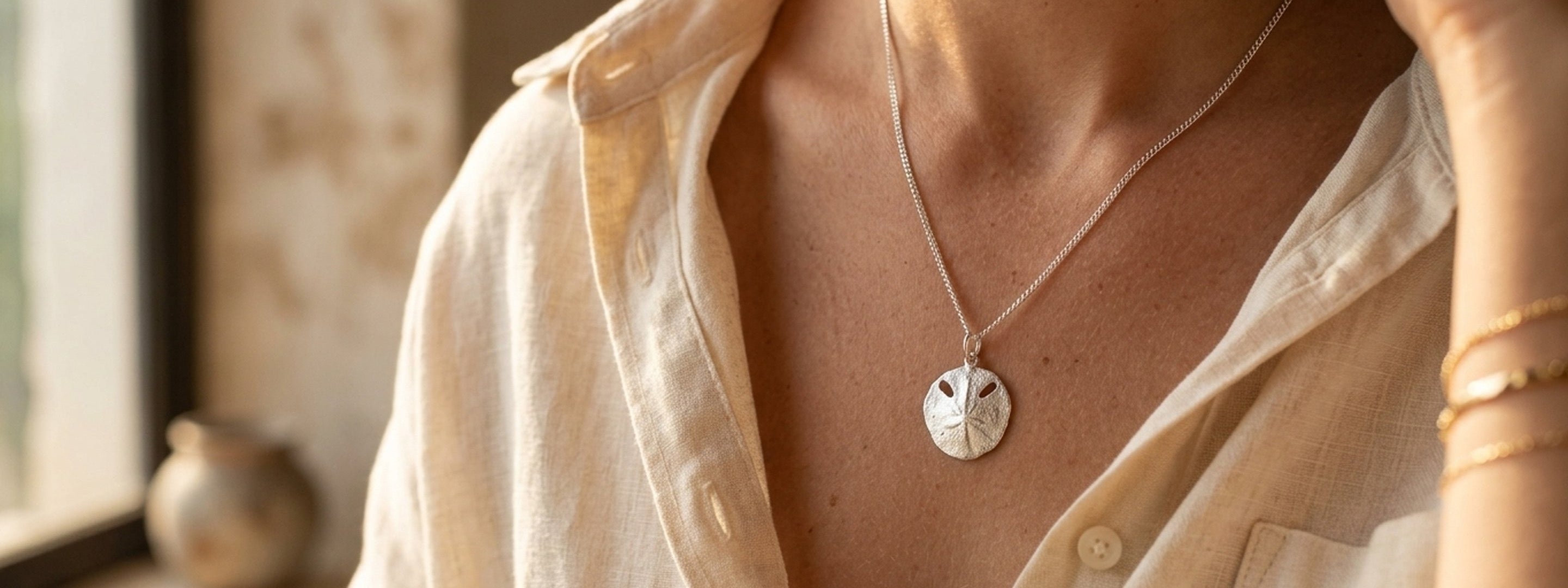 Sterling silver pendant on linen