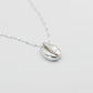 Silver shell pendant necklace on a light gray background