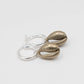 Cowry Shell Hoop Earrings - angled flat lay brass cowry on sterling silver hoop