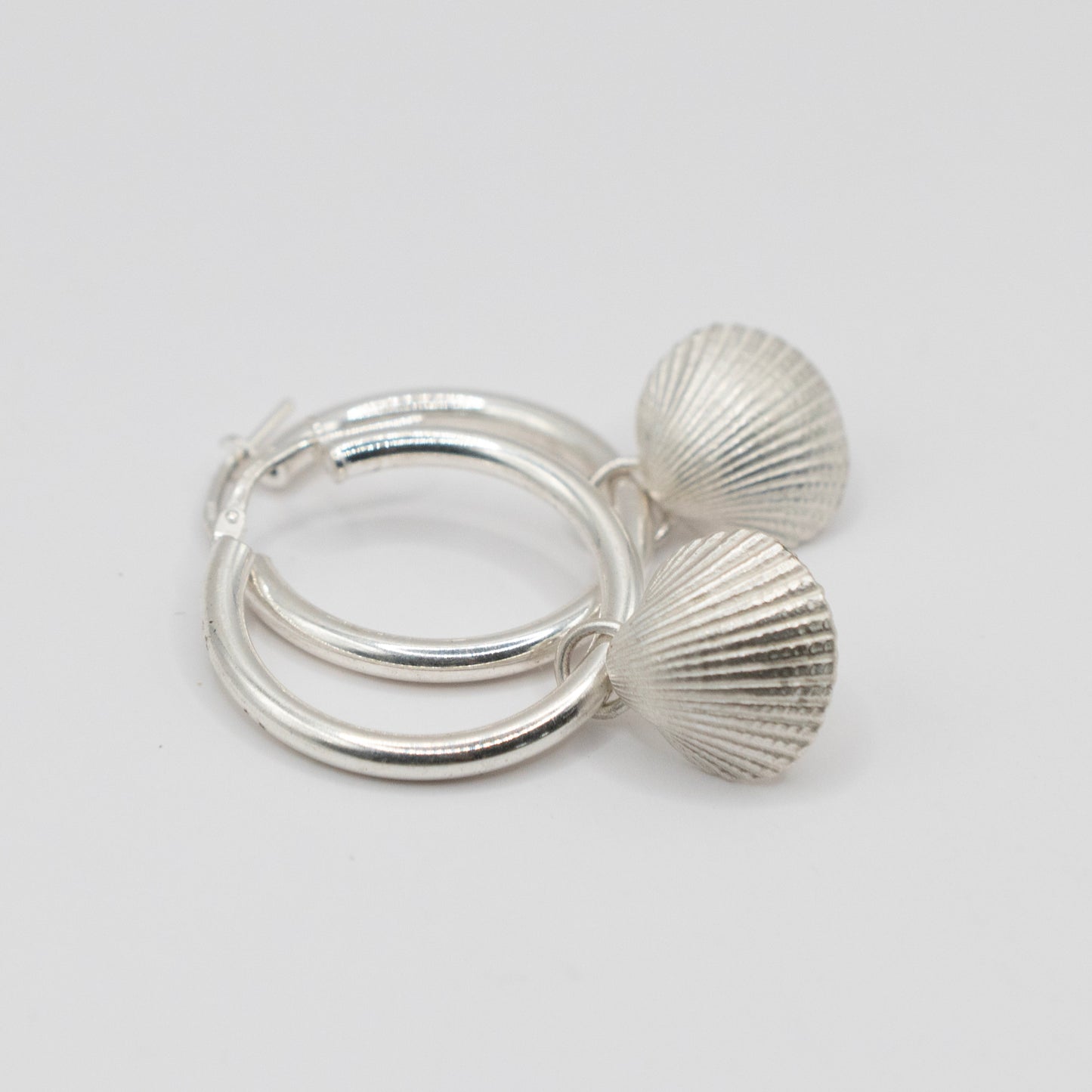 Silver hoops with scallop shell charm