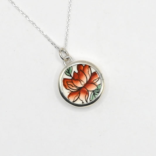Golden Lotus Bloom pendant - side angle showing sterling silver bezel depth and ceramic inlay with chain