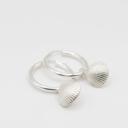 Silver Scallop Shell Hoop Earrings - sterling silver charm close-up flat lay