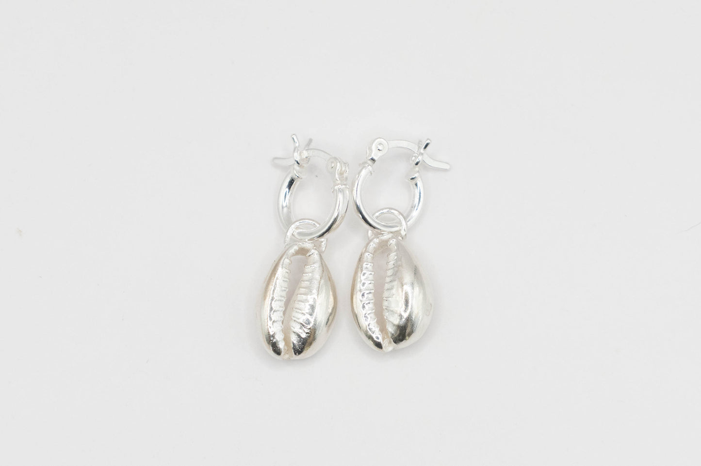 Cowry shells on silver hoops