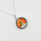 Necklace with a round pendant featuring a colorful design on a white background