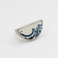 Antique blue and white ceramic half round ring worn on hand - top-down view showing statement ceramic face in sterling silver setting