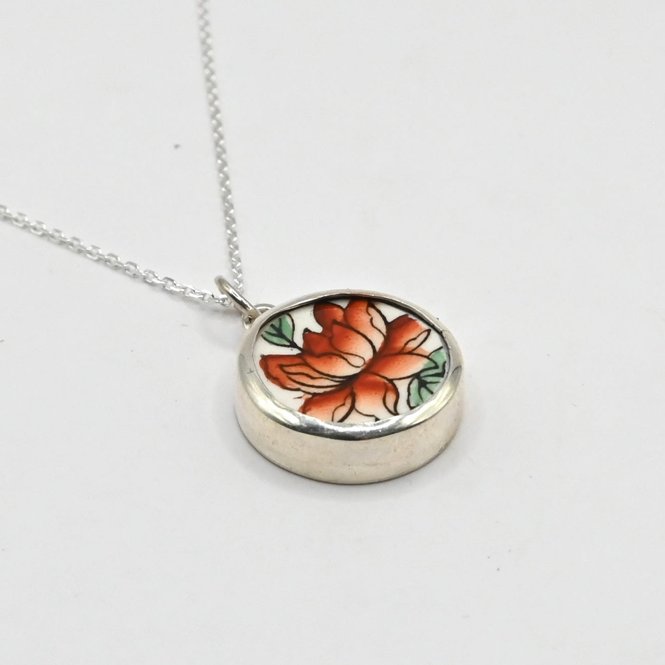 Golden Lotus Bloom pendant - front view orange and green lotus design upcycled ceramic sterling silver