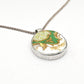 Once Upon a Teacup Pendant - angled front view, green and gold antique bone china pattern in a sterling silver bezel with snake chain