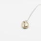 Brass Cowrie Shell Pendant Necklace - angled detail view on white background showing cast texture