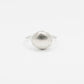 Silver shell-shaped ring on a white background
