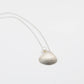 Scallop Shell Pendant Necklace - lifestyle shot on wet sand with seaweed, sterling silver shell and freshwater pearl