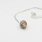 Tulip Conch Necklace - sterling silver pendant top-down spiral detail white background