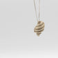 Tulip Conch Necklace - brass variant pendant hanging on grey background front view