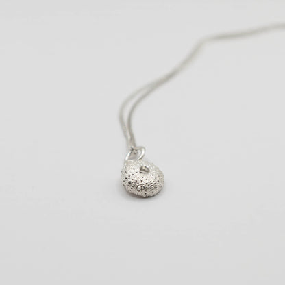 Small Sea Urchin Necklace - close-up of sterling silver sea urchin pendant showing matte textured surface