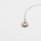 Small Sea Urchin Necklace - natural bronze sea urchin pendant on sterling silver chain, white studio background
