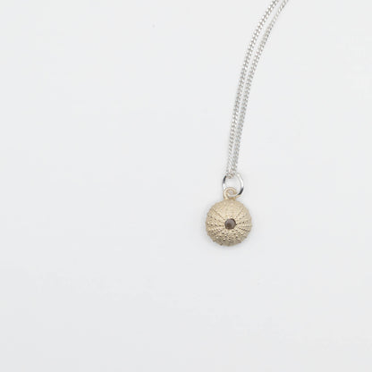 Small Sea Urchin Necklace - natural-finish sea urchin pendant on sterling silver chain, angled studio shot