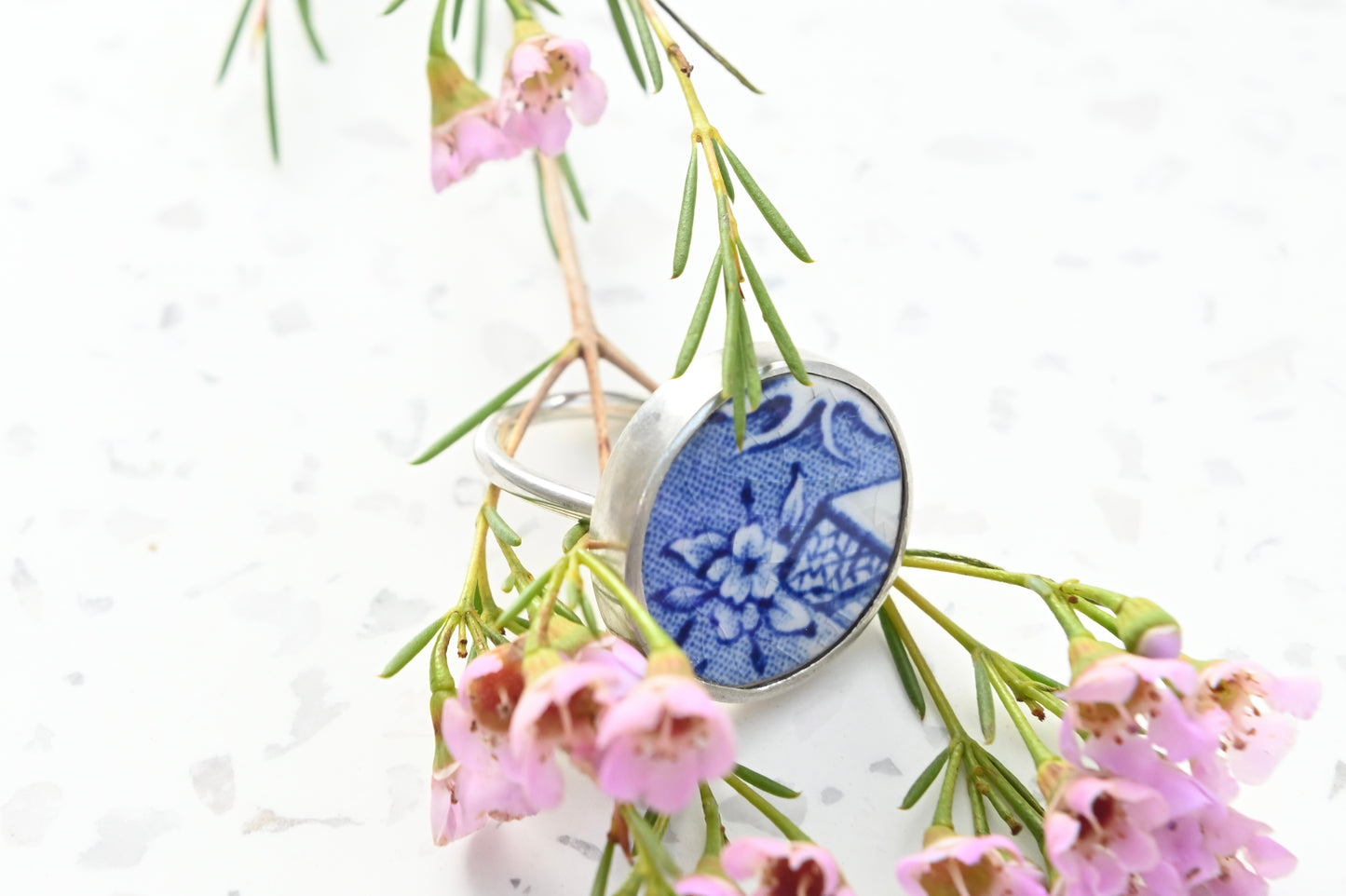 Blue and white floral ceramic ring set in silver