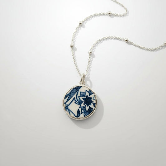 Blue and white willow-pattern ceramic pendant in sterling silver bezel setting - front view
