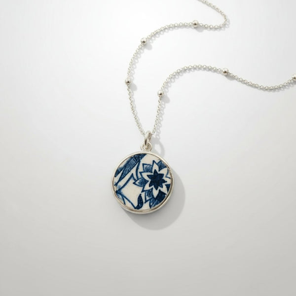 Blue and white willow-pattern ceramic pendant in sterling silver bezel setting - front view