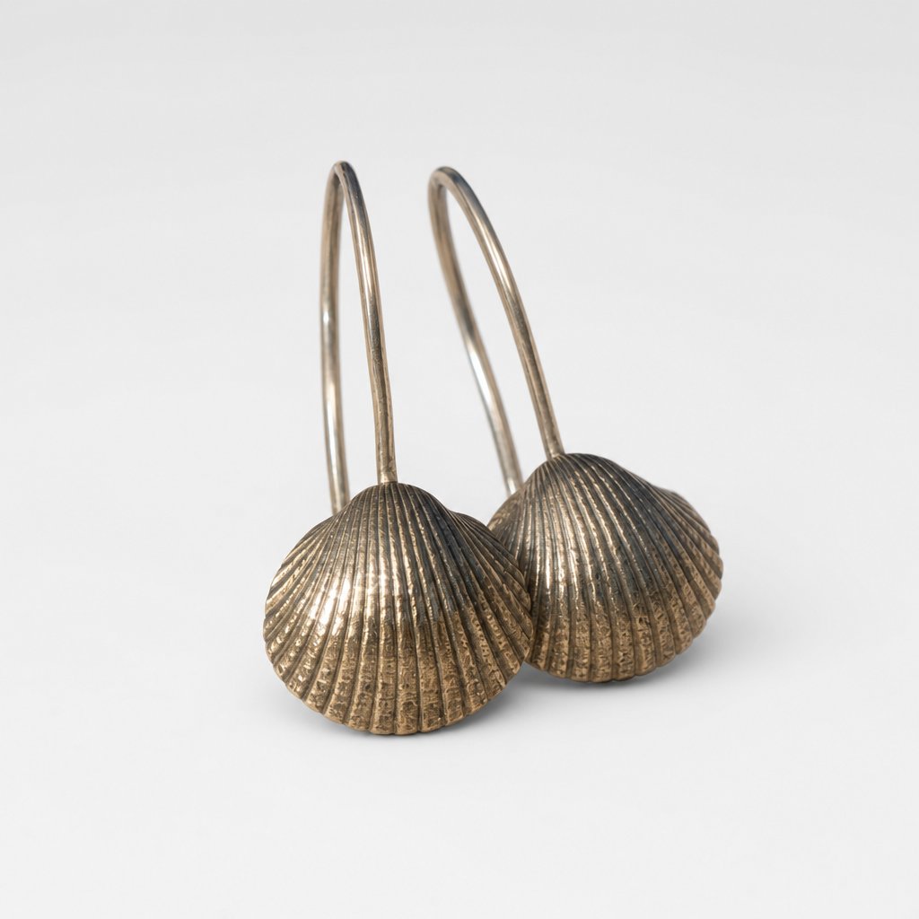 Brass Scallop Shell Earrings - lifestyle shot on rock surface with sterling silver hooks