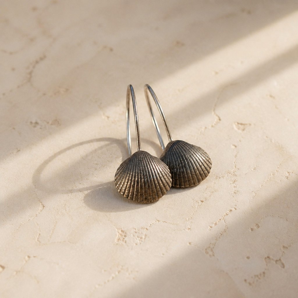 Brass Scallop Shell Earrings - pair flat lay on white background showing ribbed detail and silver hooks
