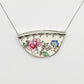 Broken Plate Blooming Again Pendant - closer angle showing pink rose and blue floral antique china set in sterling silver