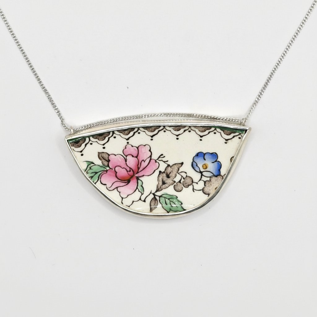 Broken Plate Blooming Again Pendant - closer angle showing pink rose and blue floral antique china set in sterling silver