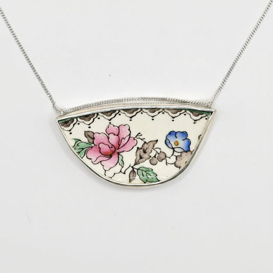 Broken Plate Blooming Again Pendant - closer angle showing pink rose and blue floral antique china set in sterling silver