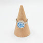 Ceramic Flower Ring from Antique Plate - front view on wooden ring cone, sterling silver bezel setting